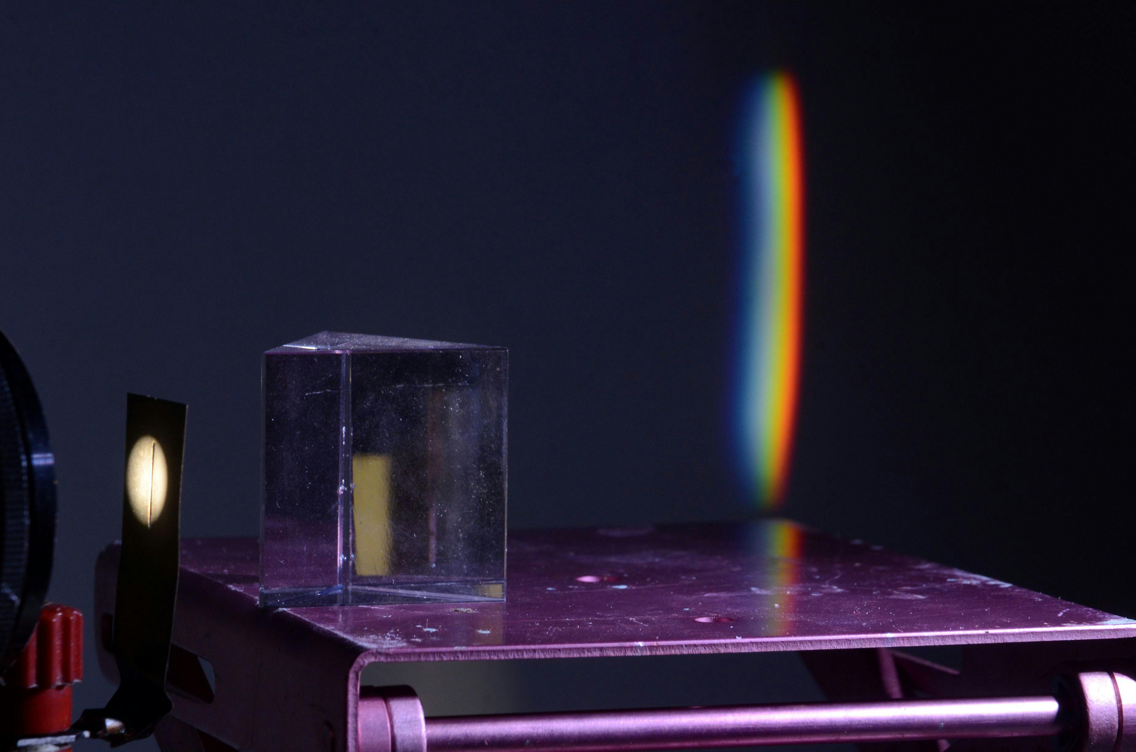 Refraction of white light in a prism, a spectre is projected on the wall in the background. | Image Credit: © Kim - stock.adobe.com