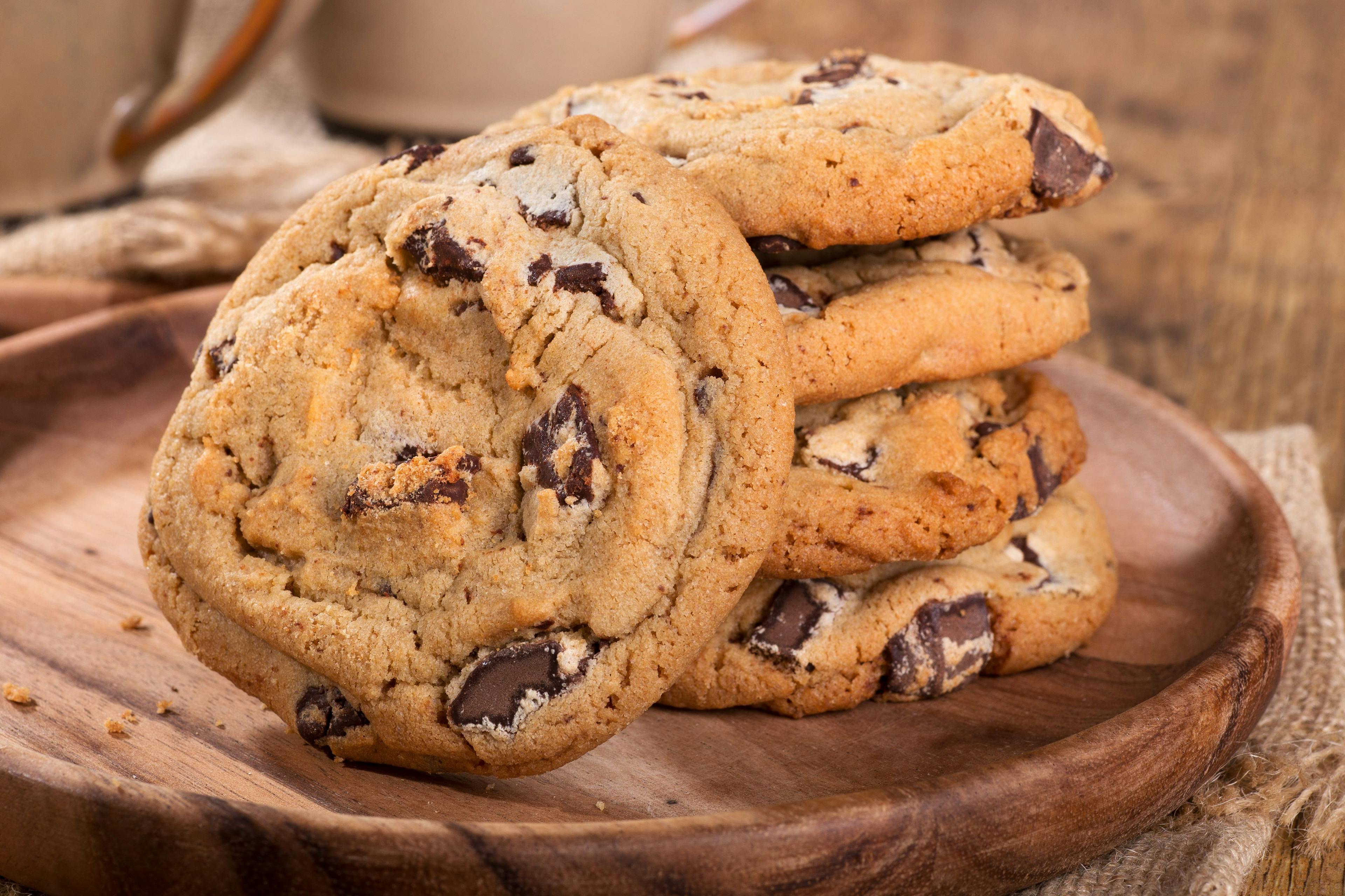 Closeup of chocolate chip cookies on a wooden plate | Image Credit: © chas53 - stock.adobe.com