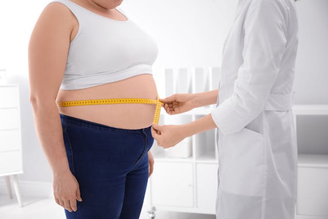 Doctor measuring waist of overweight woman in clinic, closeup | Image Credit: © New Africa - stock.adobe.com