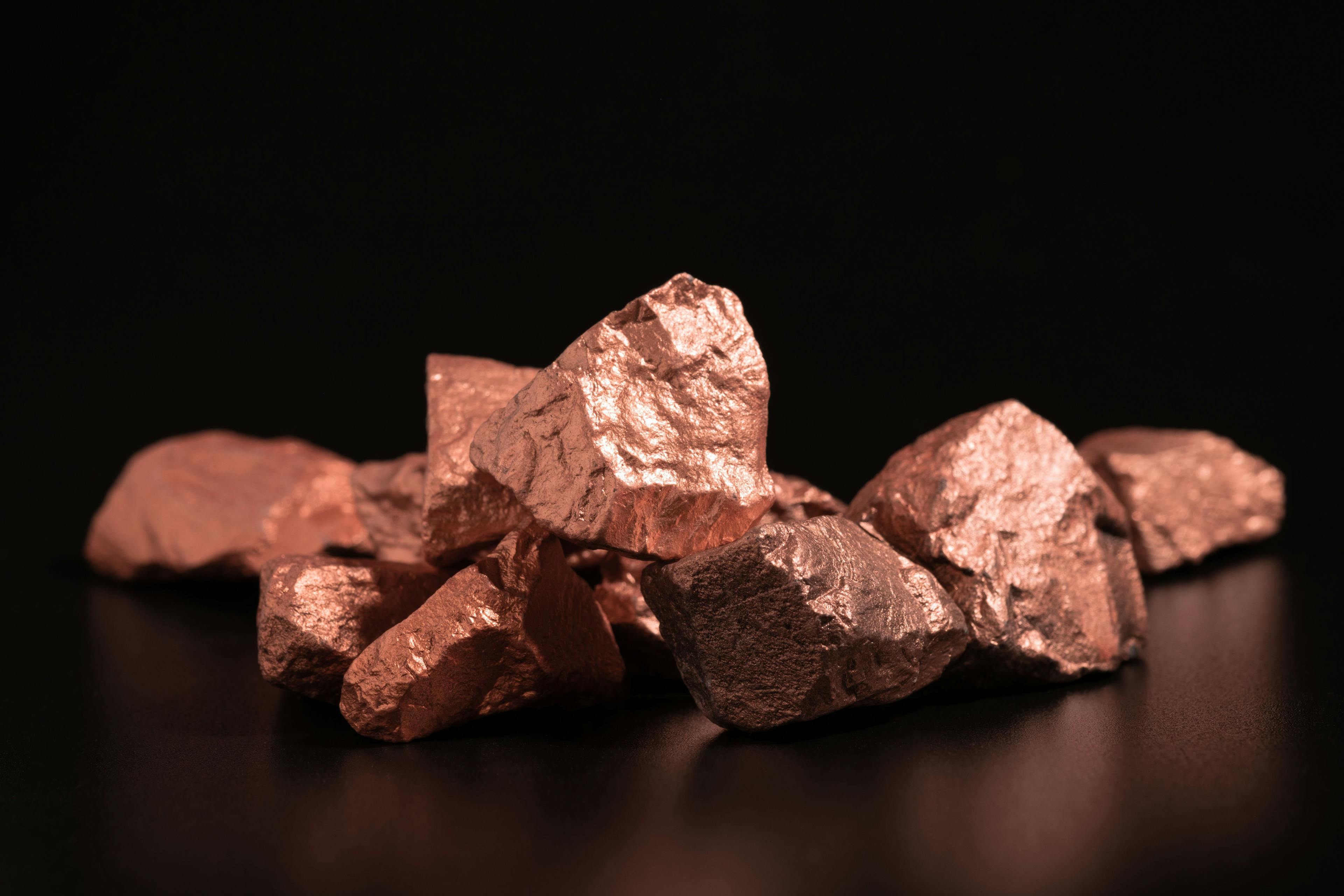 Ingots of pure copper or pink gold on a black background. | Image Credit: © Phawat - stock.adobe.com