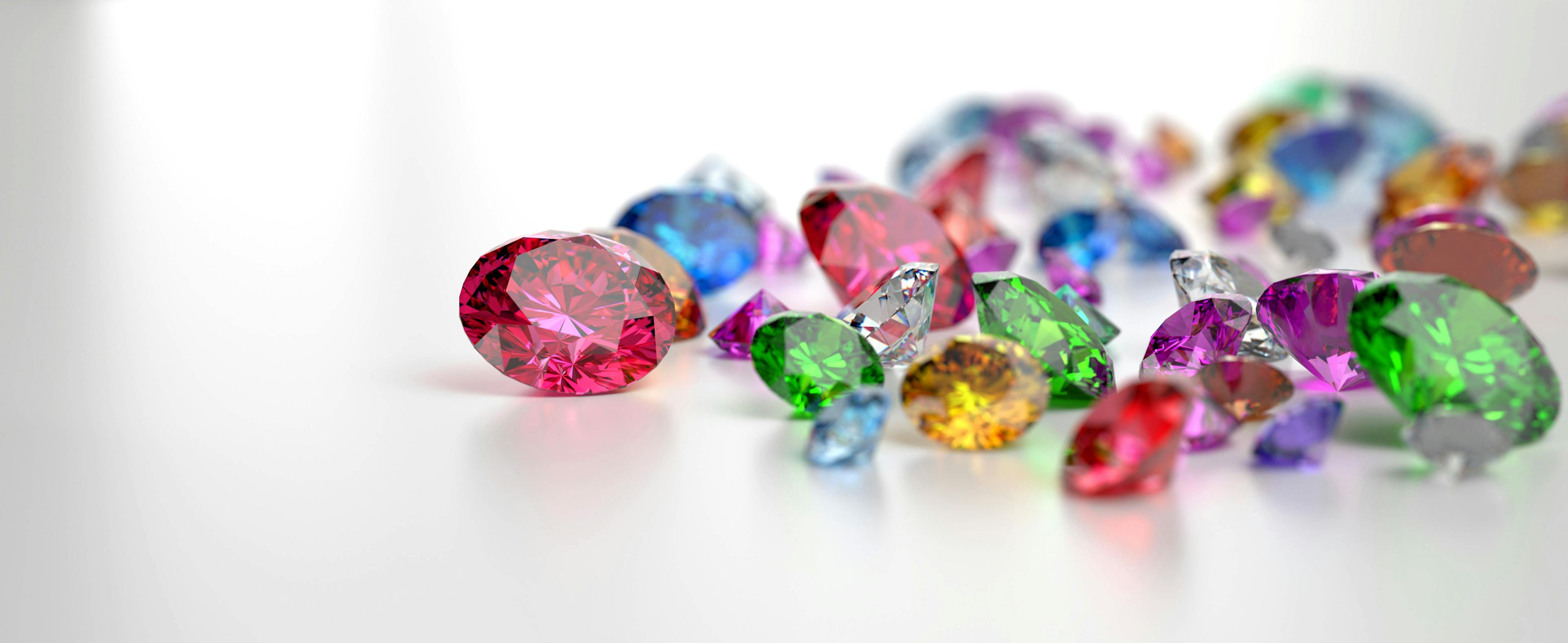 Colorful Gemstones placed on white reflection background, 3d rendering. | Image Credit: © sarawut795 - stock.adobe.com