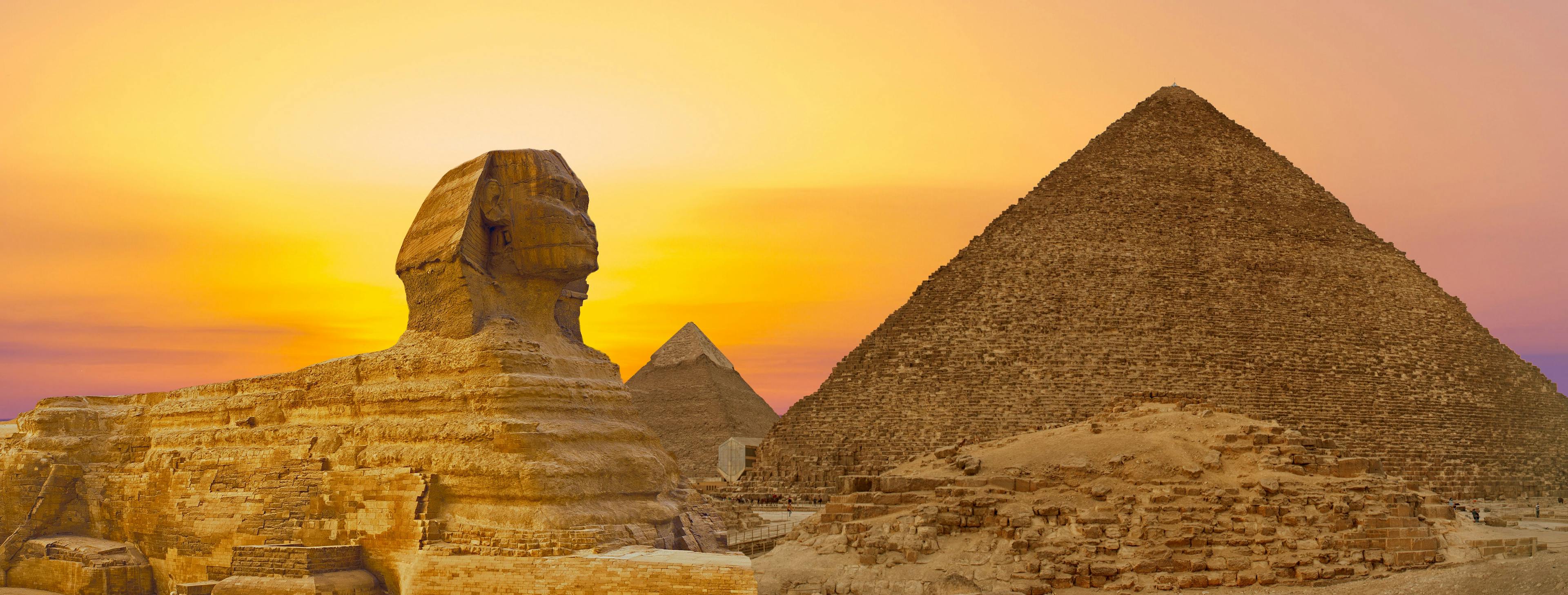 Sphinx against the backdrop of the great Egyptian pyramids. Africa, Giza Plateau. | Image Credit: © Mountains Hunter - stock.adobe.com 