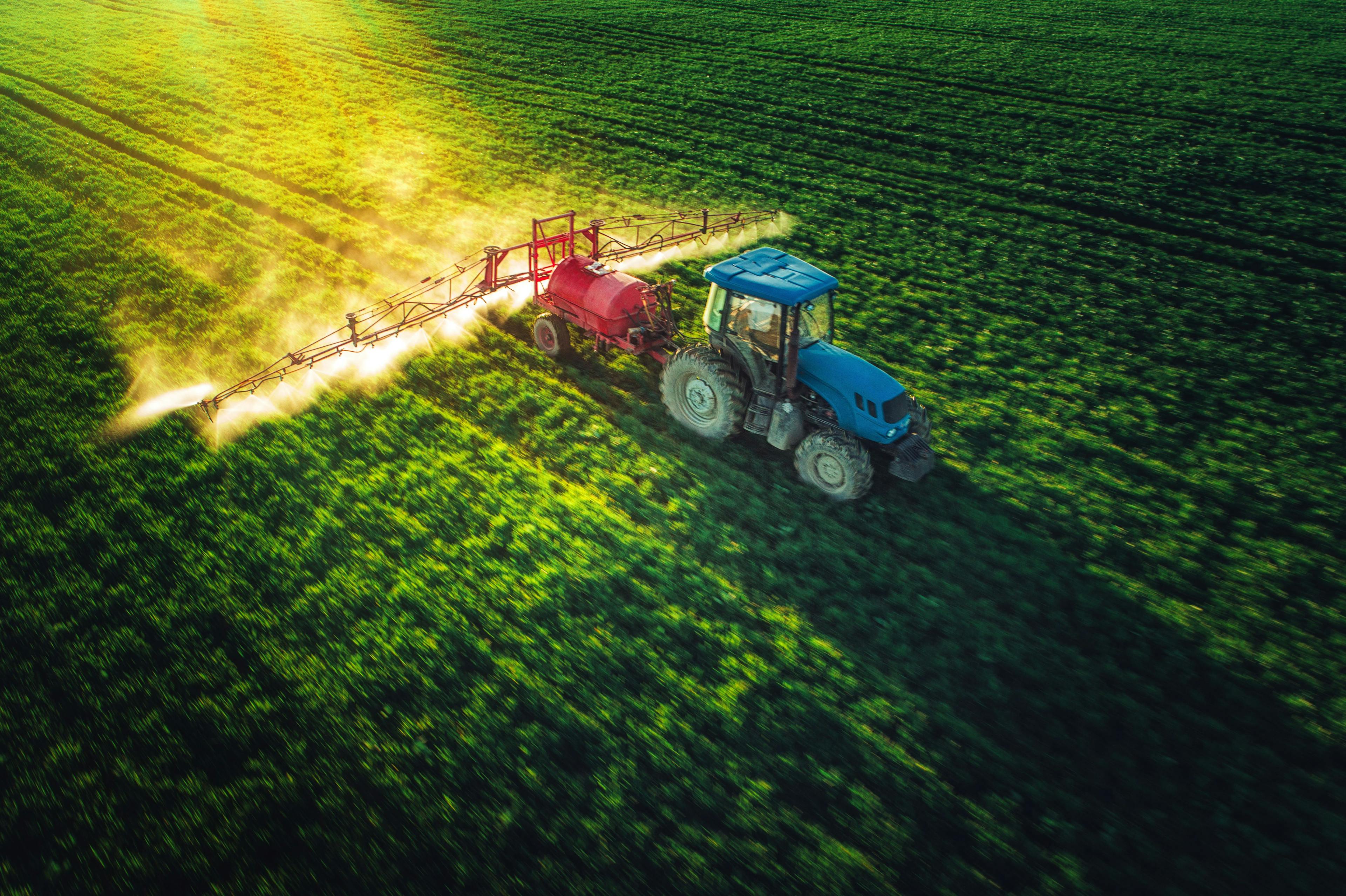 Aerial view of farming tractor plowing and spraying on field | Image Credit: © ValentinValkov - stock.adobe.com.