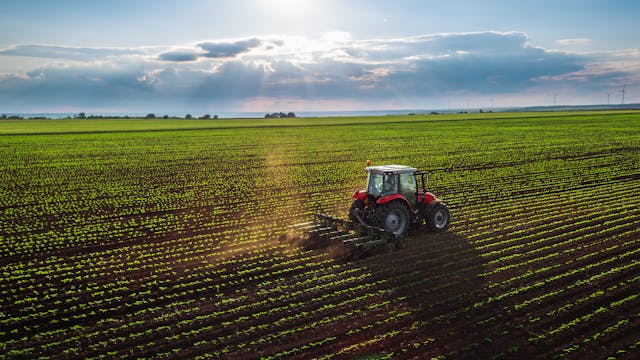 Tractor cultivating field at spring | Image Credit: © ValentinValkov