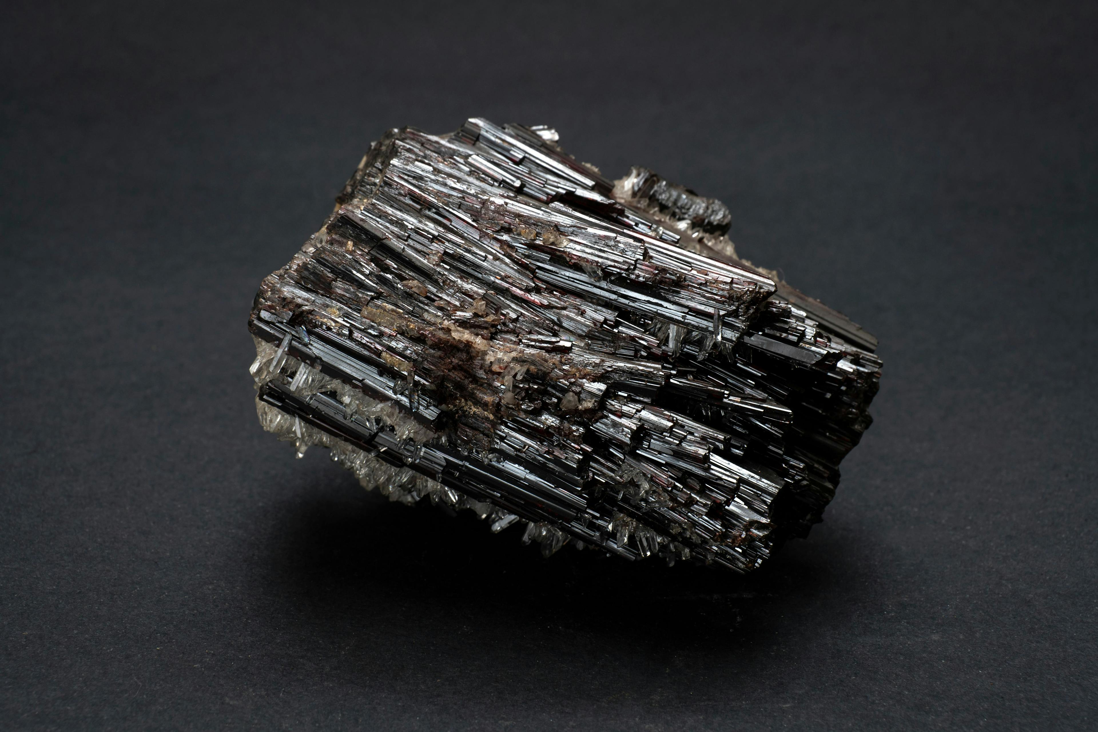 Piece of Hubnerite mineral from Pasto Bueno, Peru. A mineral consisting of manganese tungsten oxide with black monoclinic prismatic submetallic crystals with fine striations | Image Credit: © MyriamB - stock.adobe.com
