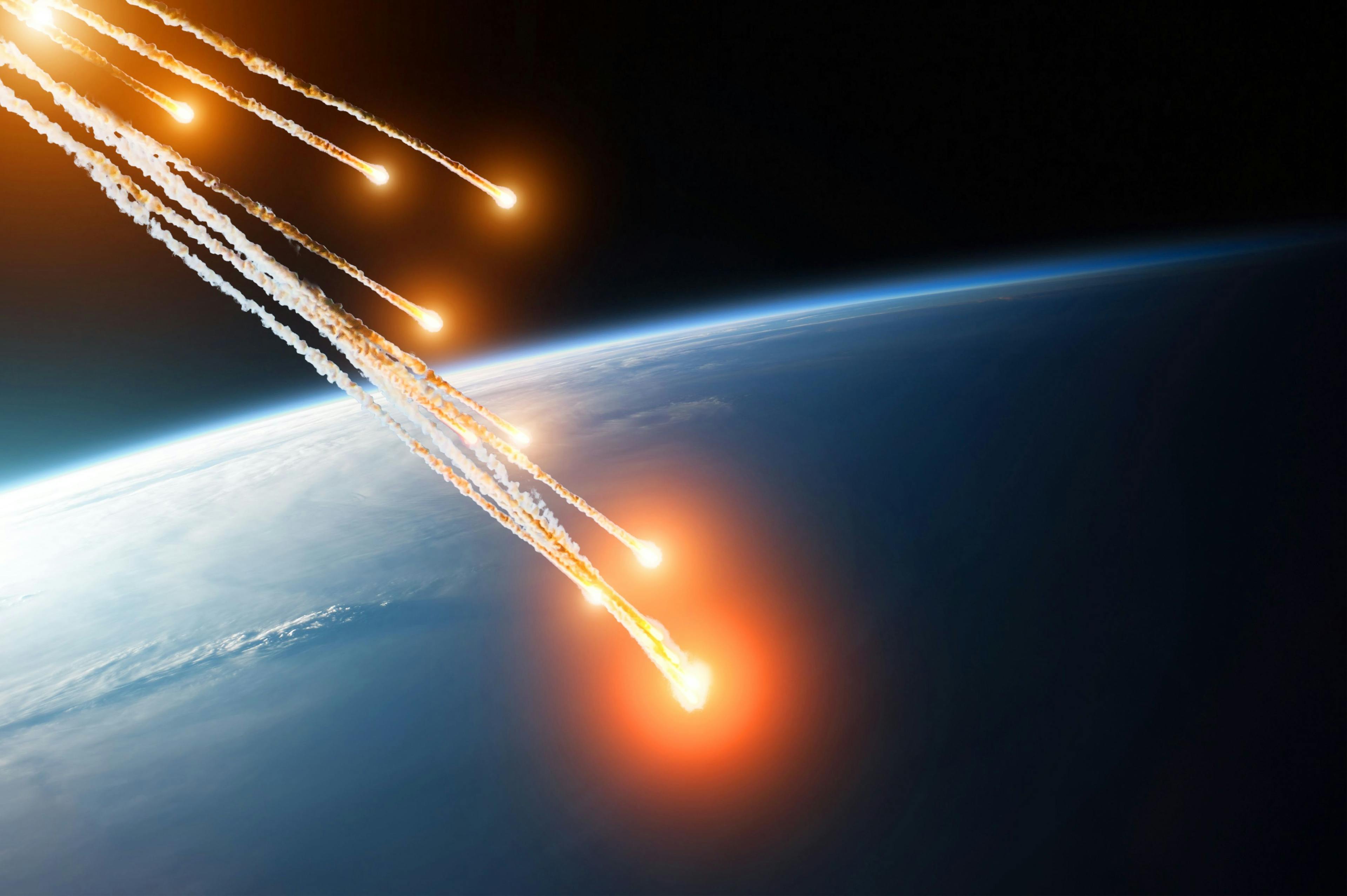 Falling burning flares of several meteorites of asteroids in the Earth's atmosphere. Elements of this image furnished by NASA. | Image Credit: © aapsky - stock.adobe.com
