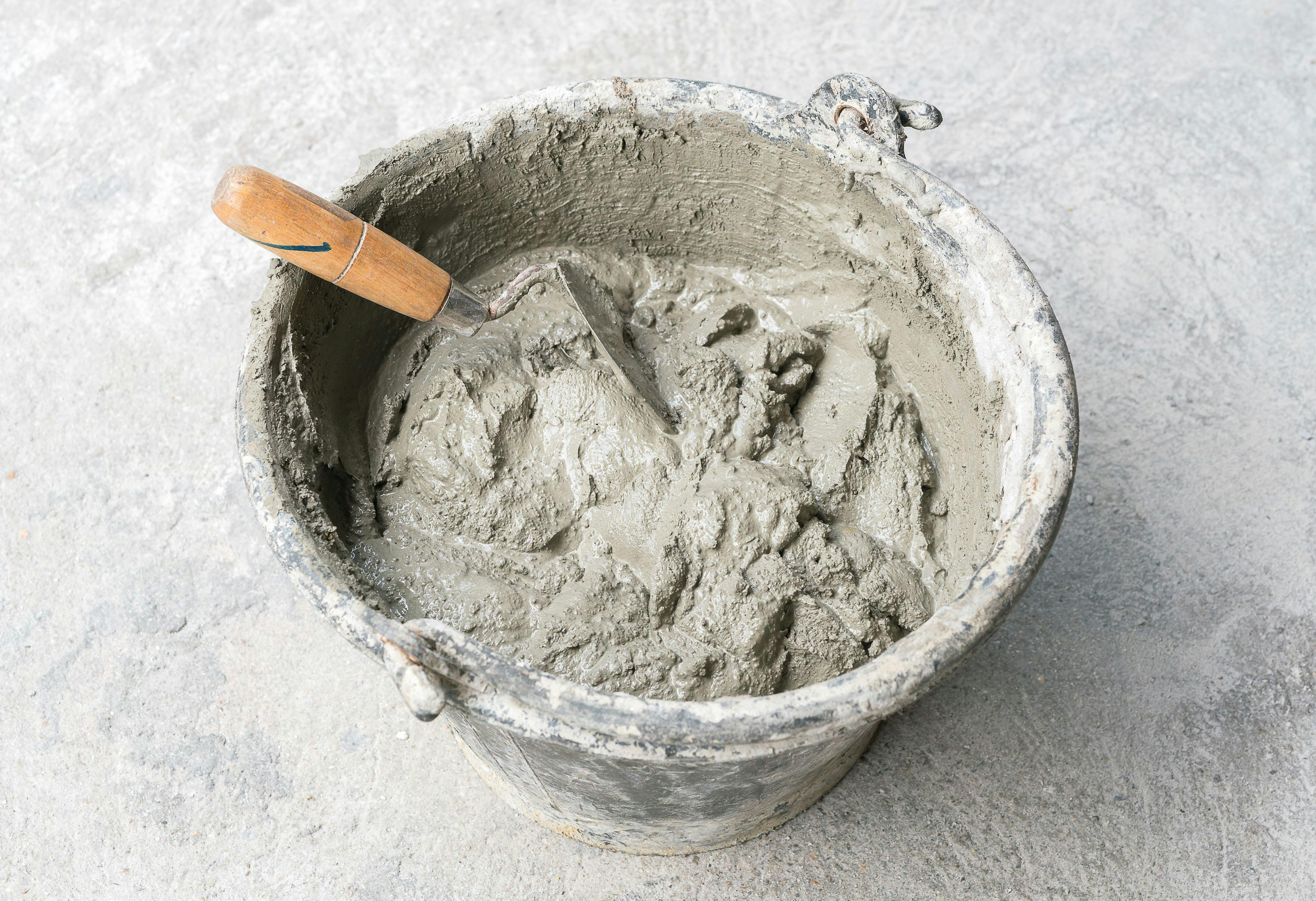 Pick up a trowel and cement mix concrete is compacted sand