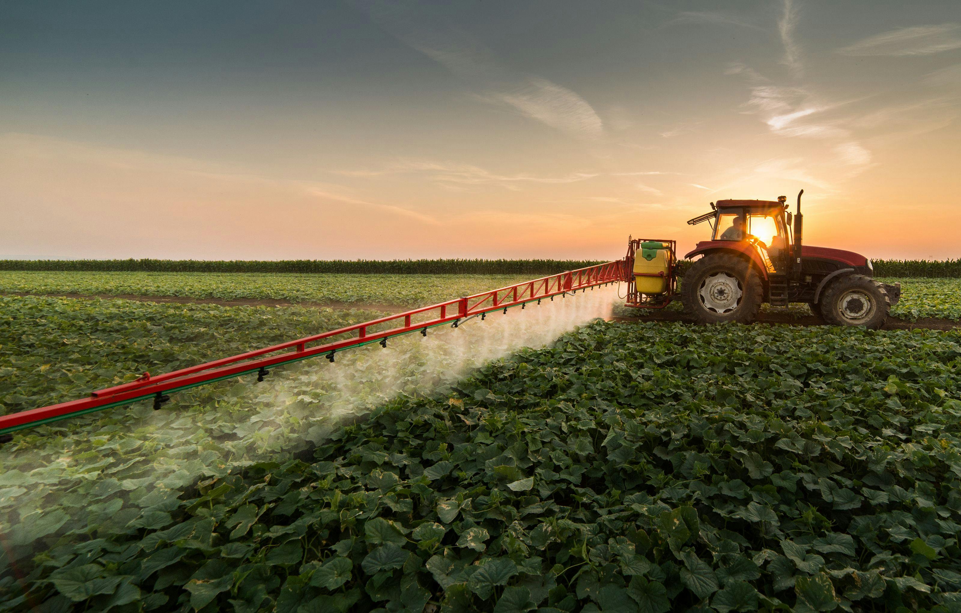 Tractor spraying pesticides on vegetable field with sprayer at spring | Image Credit: © Dusan Kostic - stock.adobe.com