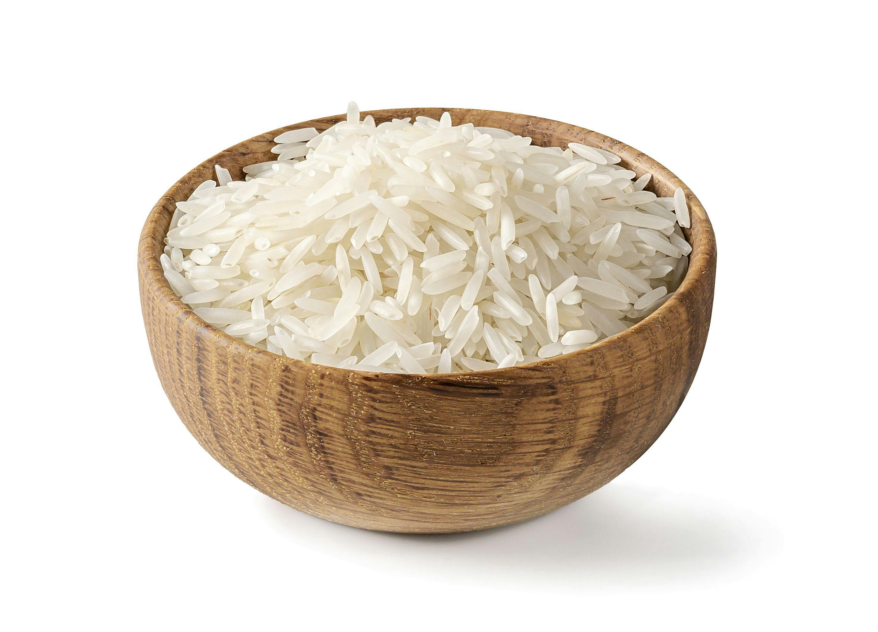 Dry white long rice basmati in wooden bowl isolated on a white background. | Image Credit: © Soho A studio - stock.adobe.com