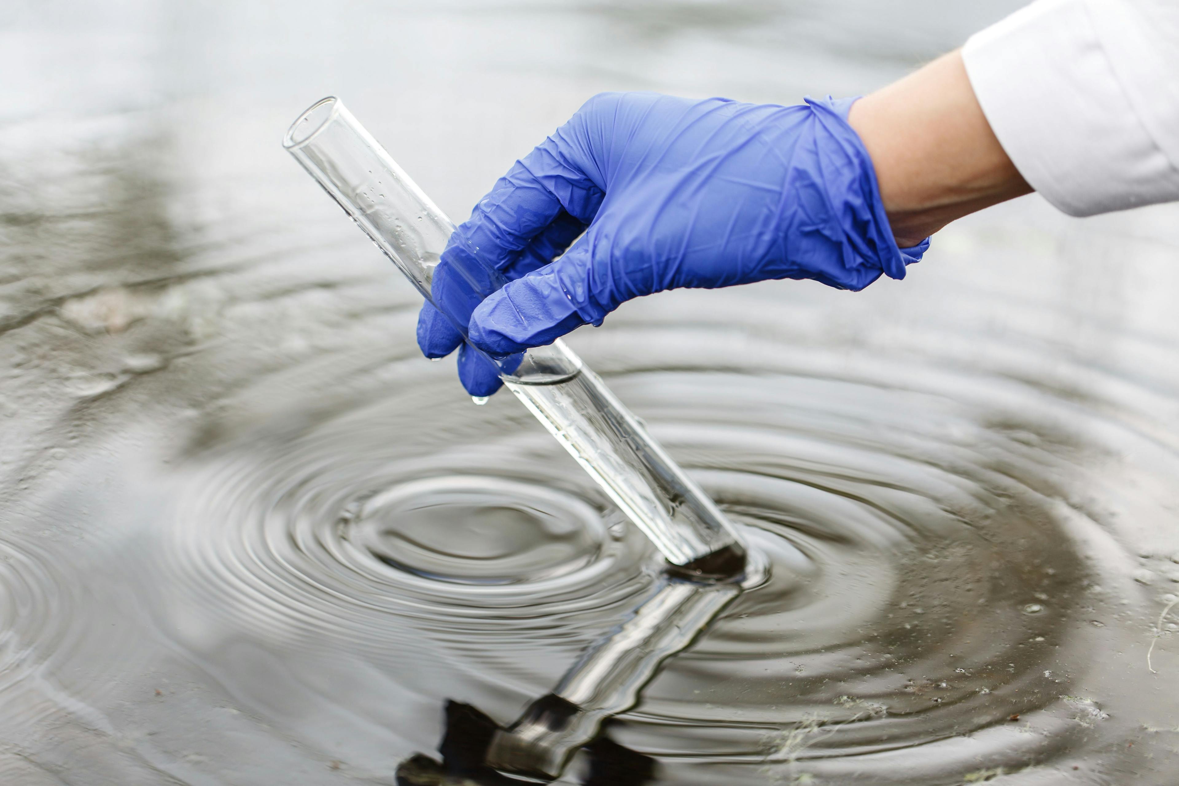 Researcher holds a test tube with water in a hand in blue glove | Image Credit: © IVASHstudio - stock.adobe.com