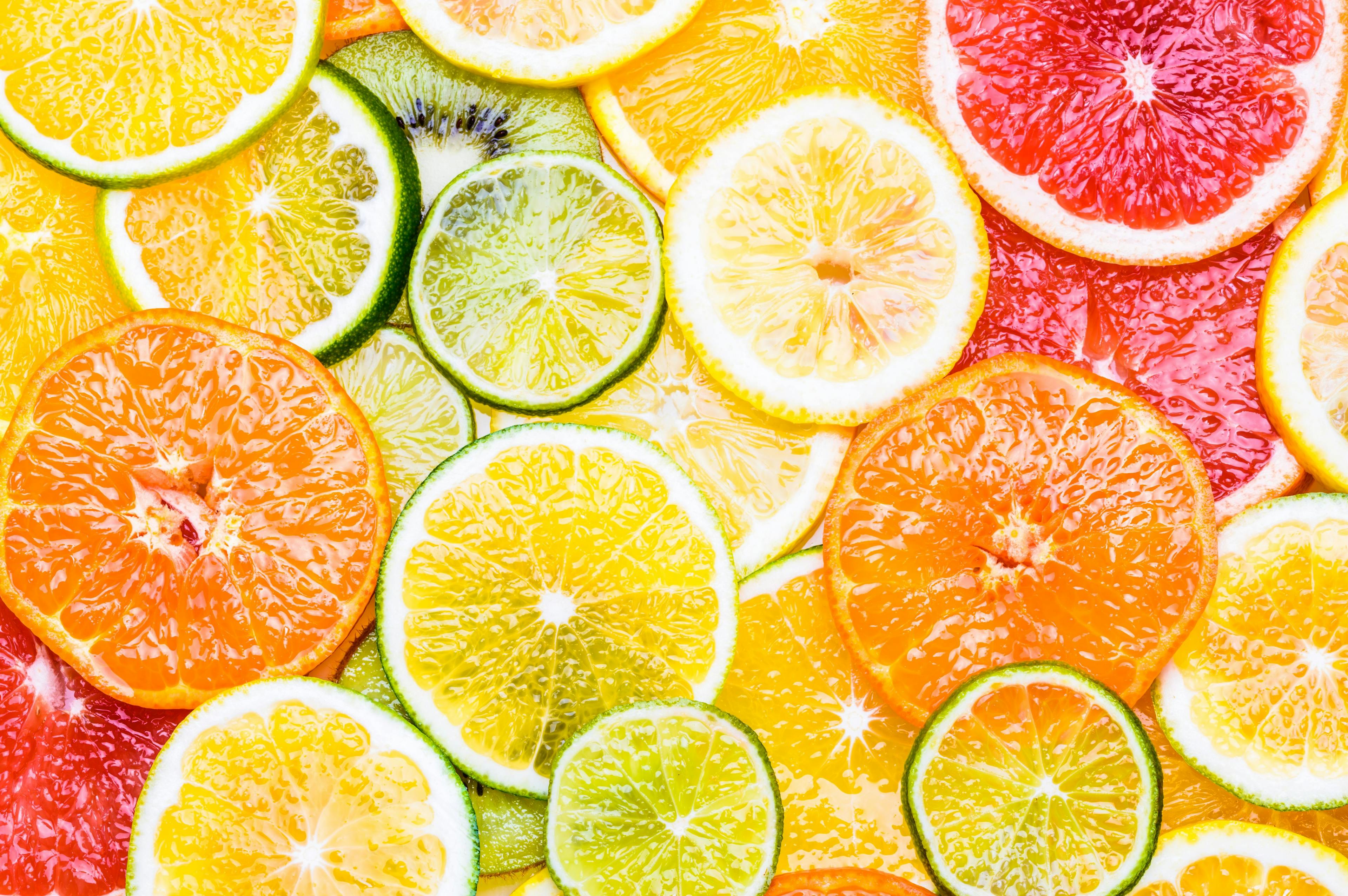 Citrus fruits background various slices top view background. Vitamin c fruits. | Image Credit: © travelbook - stock.adobe.com