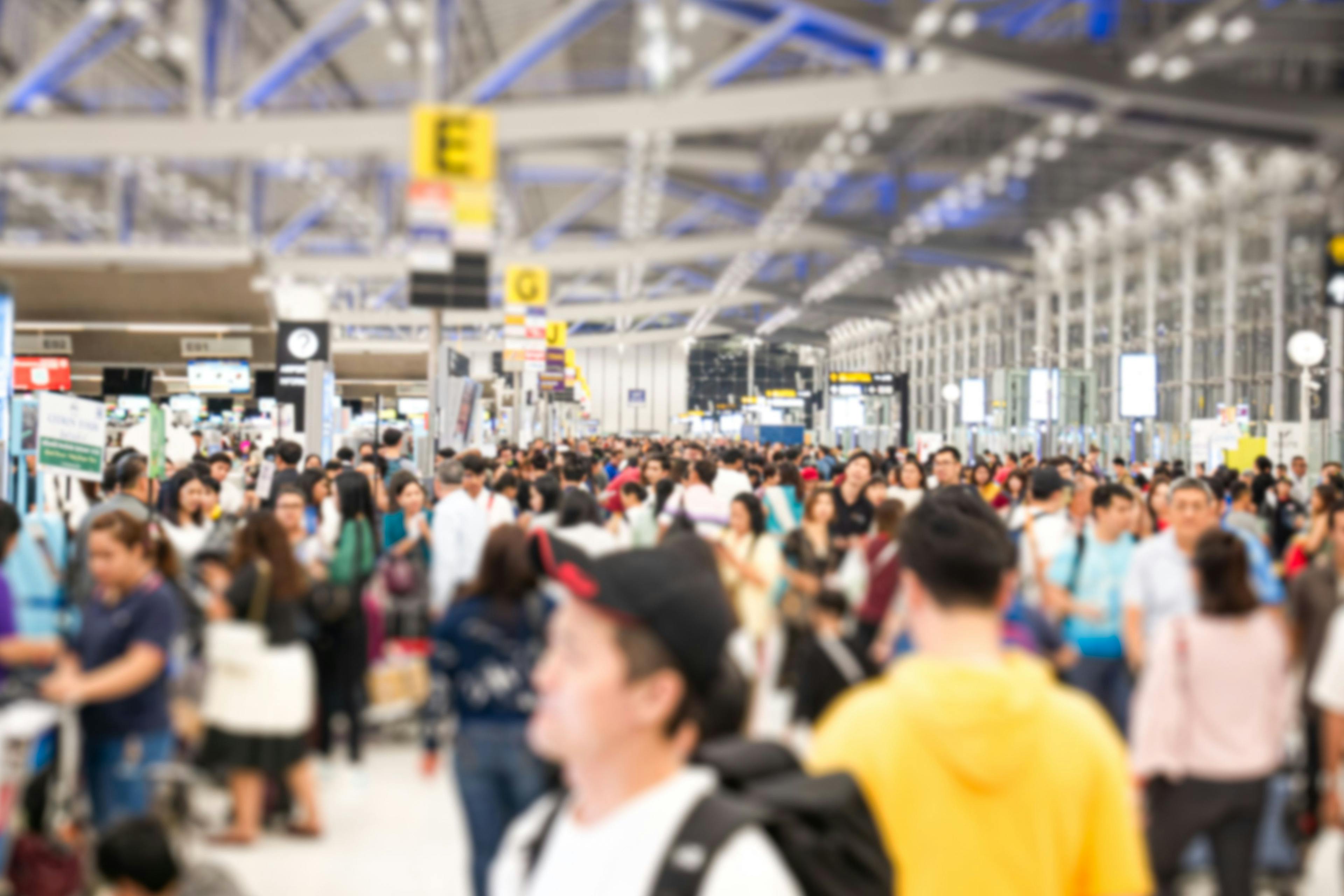 Blurred many passengers people of crowd anonymous walking at the airport. scene of airport with passengers activity. Terminal Departure Check-in at airport. Travel International and business concept. | Image Credit: © setthawuth - stock.adobe.com
