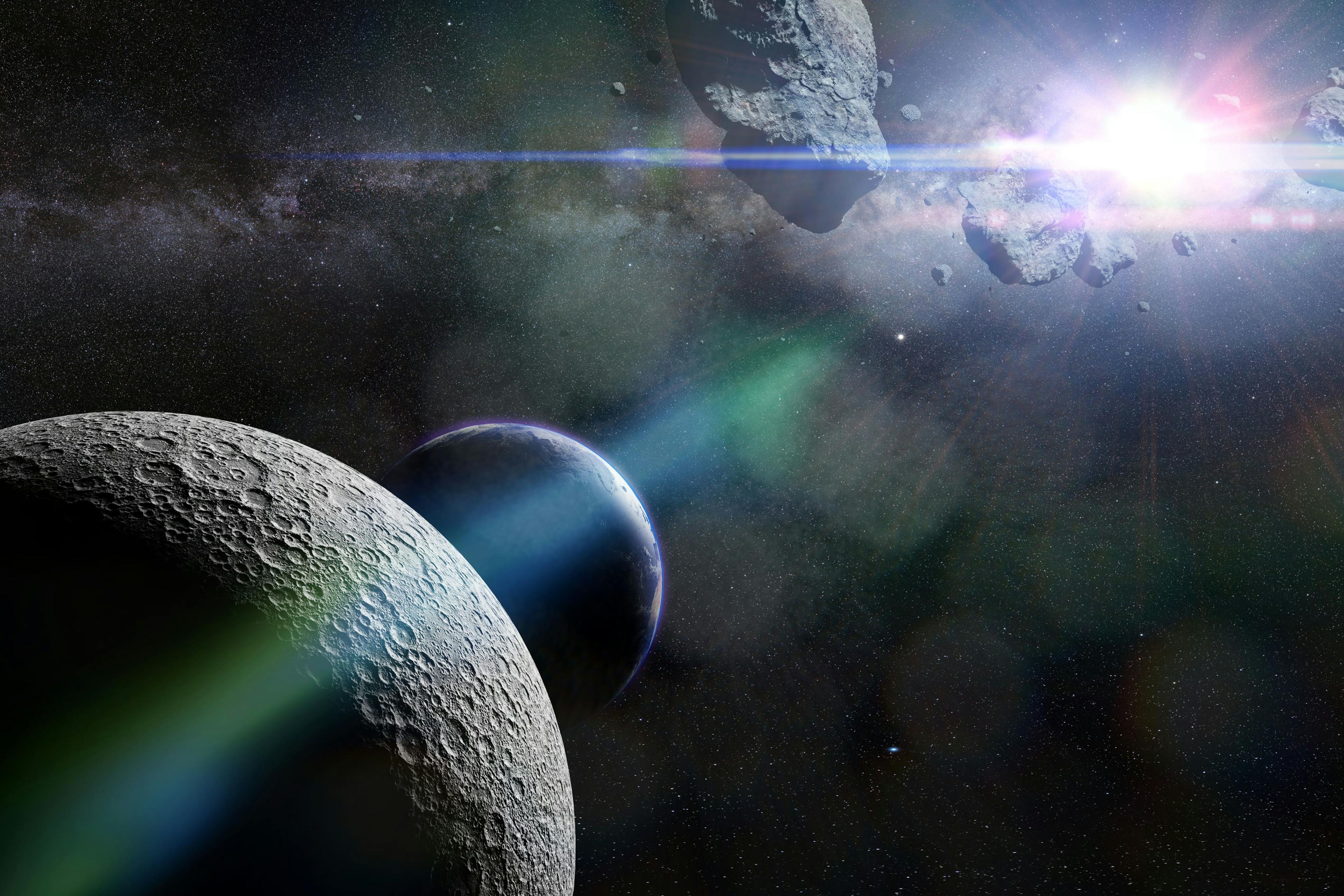 A swarm of asteroids moving towards planet Earth crossing the Moon's orbit | Image Credit: © dottedyeti - stock.adobe.com